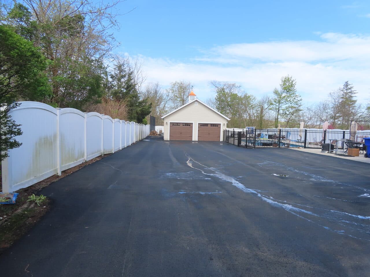 Multi-Stop Residential Driveway Paving project in Wallingford, Branford & Northford, CT — fresh asphalt driveway by garage