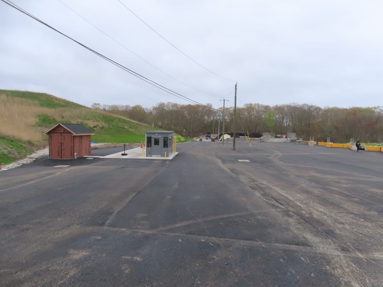 Commercial Parking Lot Paving project in East Lyme, CT — finished asphalt lot with guard booths
