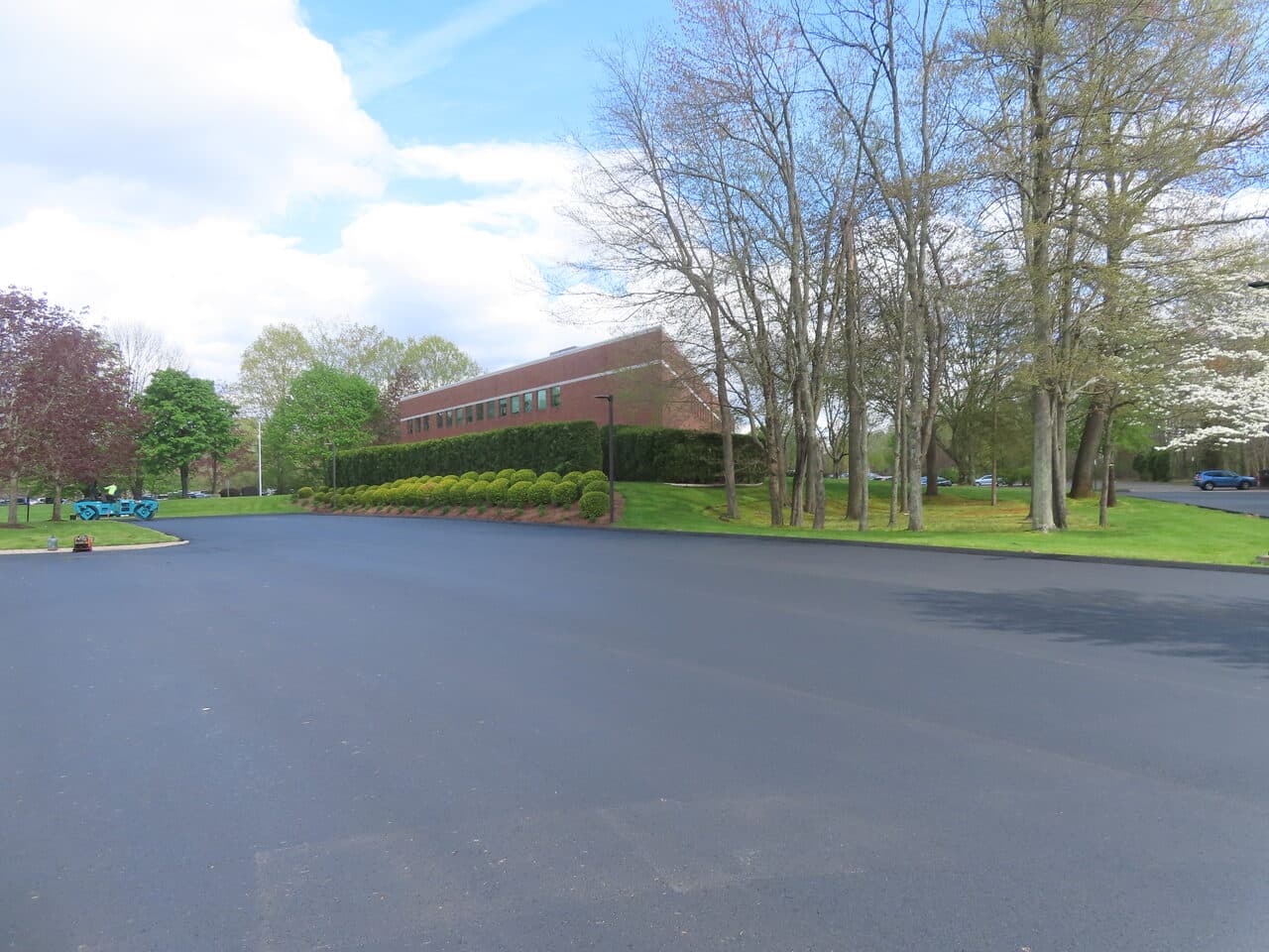 Commercial Sealcoating project in Glastonbury, CT — wide fresh sealed lot with landscaping