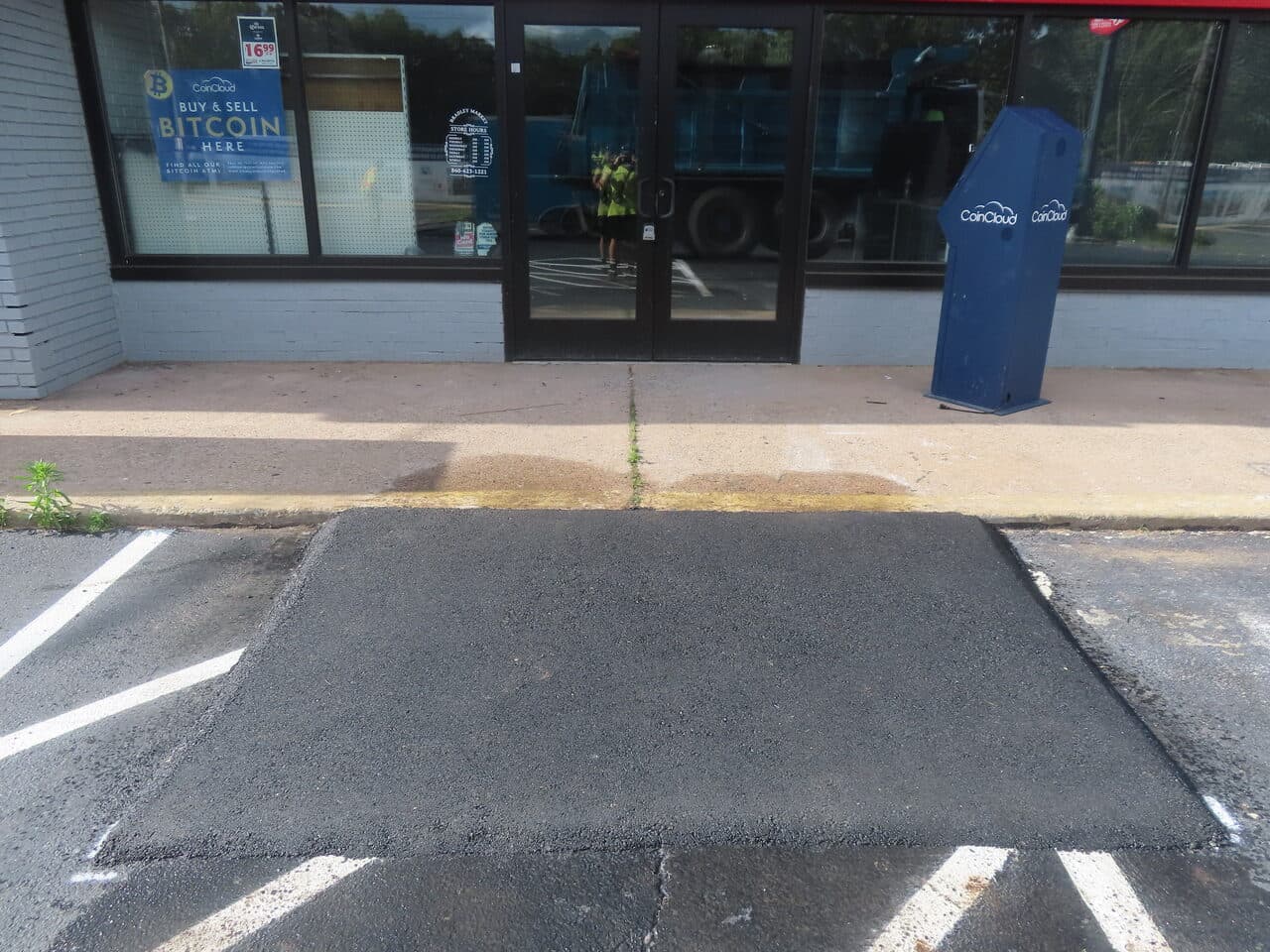 ADA Storefront Pad Installation project in Waterbury, CT — fresh asphalt patch at storefront