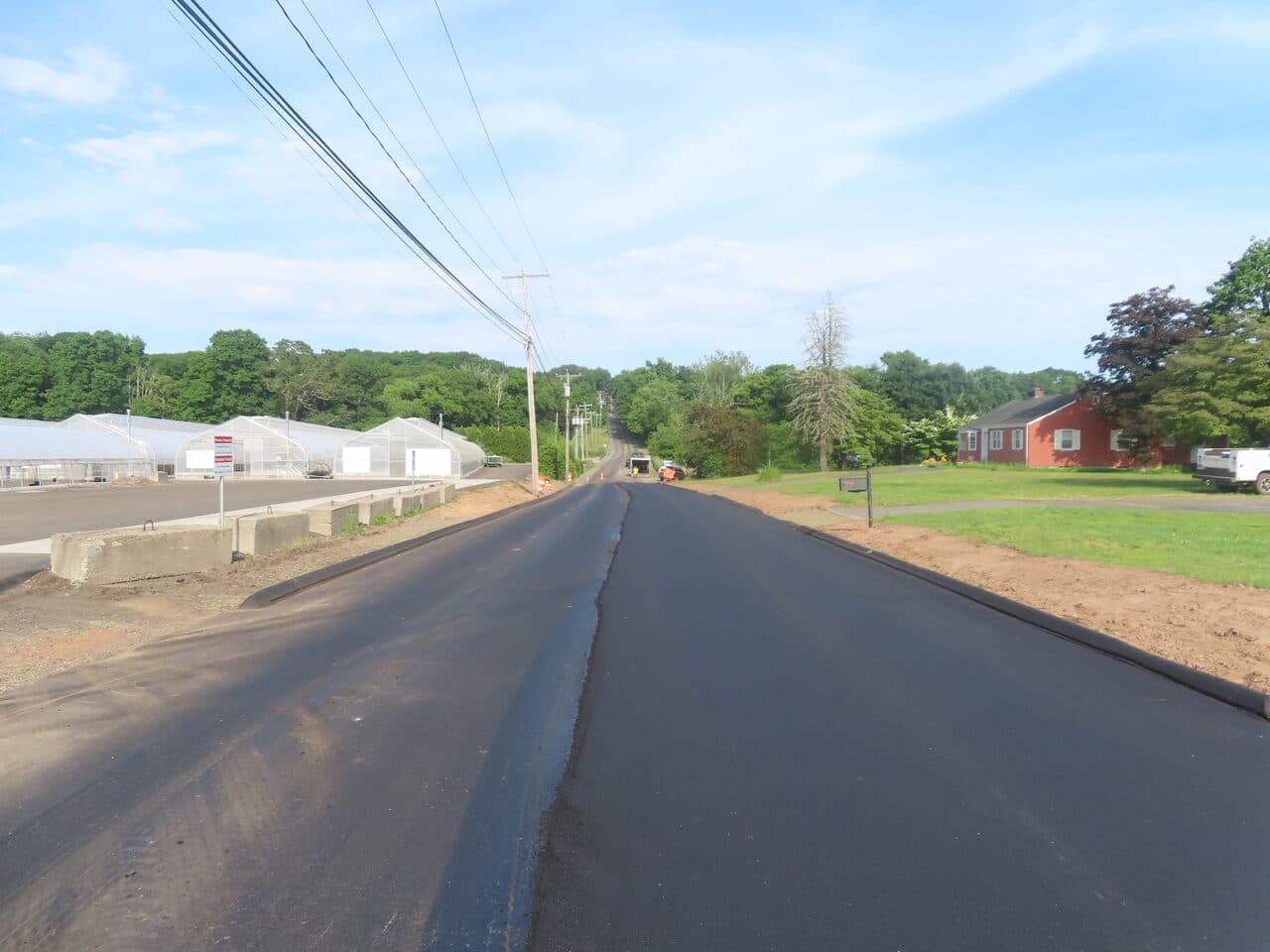 Roadway Paving project in Cheshire, CT — finished paved road past greenhouses