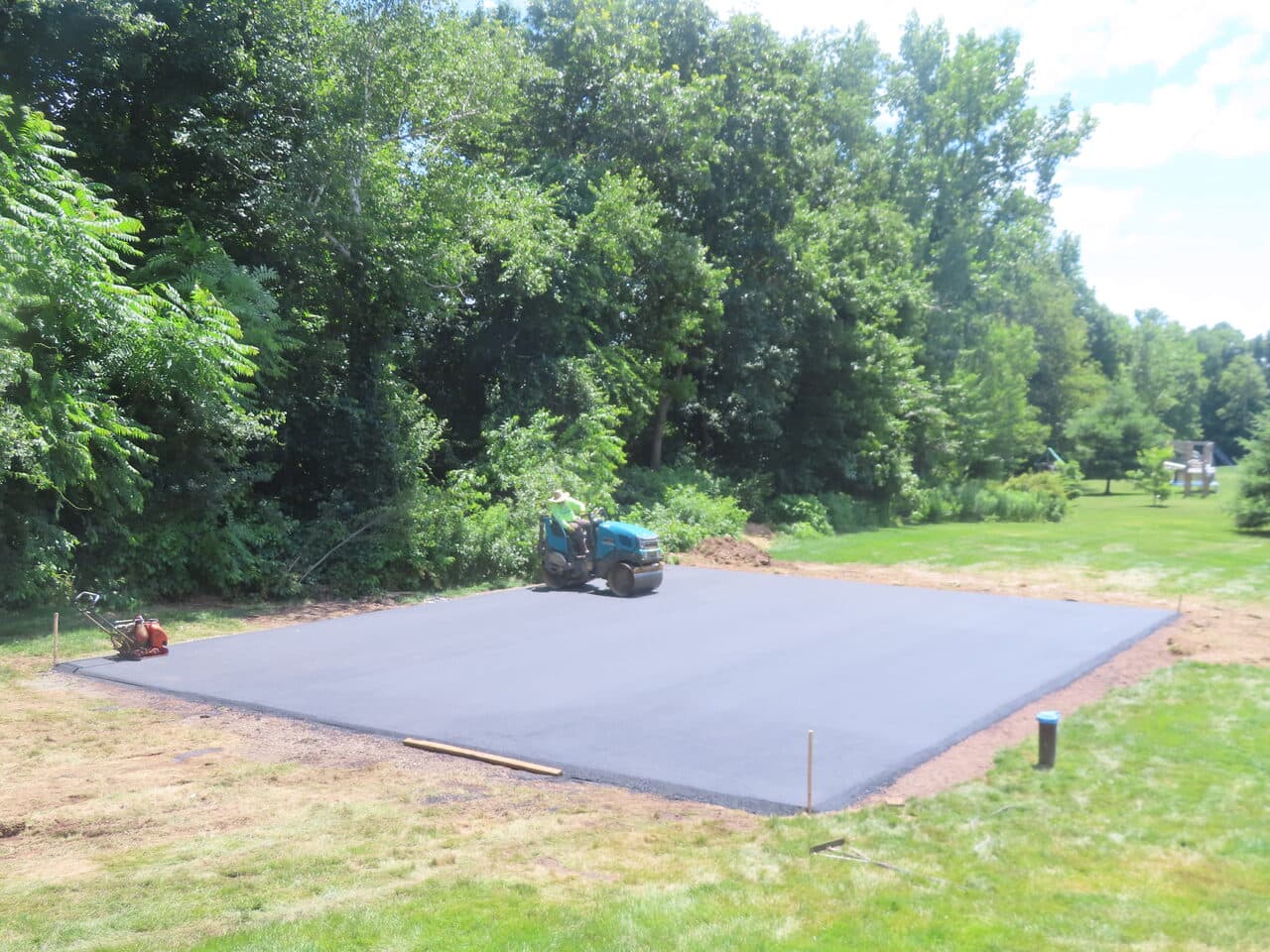 Asphalt Pad Paving project in North Haven, CT — finished asphalt pad with roller