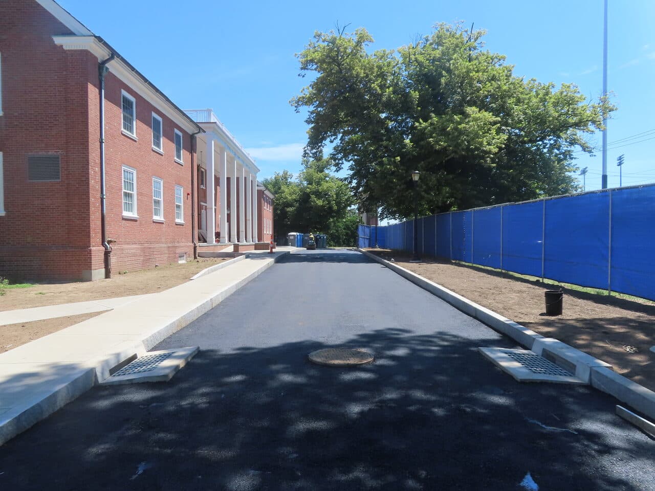 Institutional Asphalt Paving project in New Haven, CT — finished access road with drainage grates