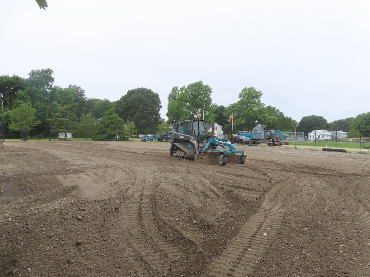 Athletic Facility Parking Lot Paving project in Rhode Island, RI — skid steer grading subgrade