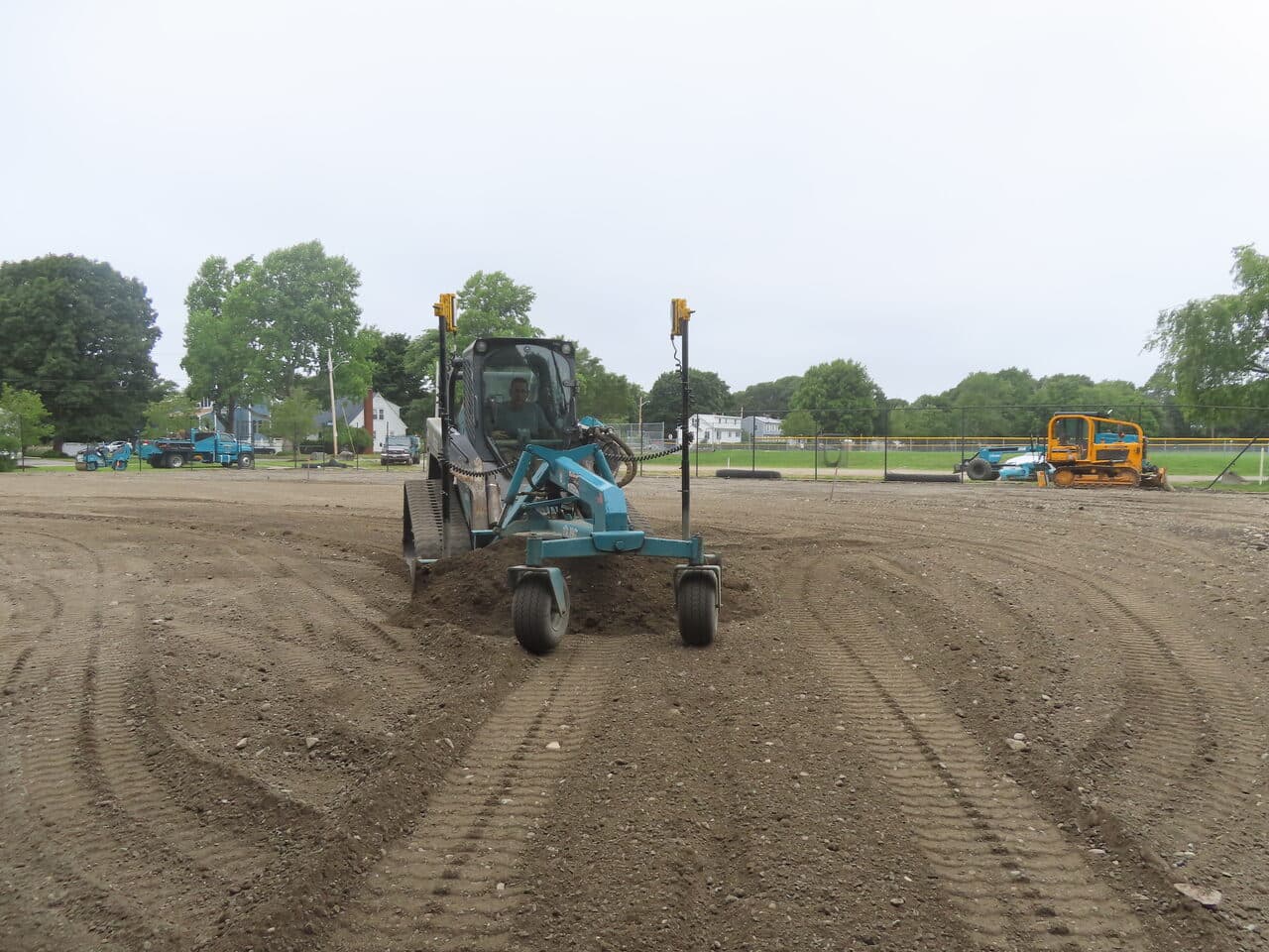 Athletic Facility Parking Lot Paving project in Rhode Island, RI — skid steer grading subgrade head on