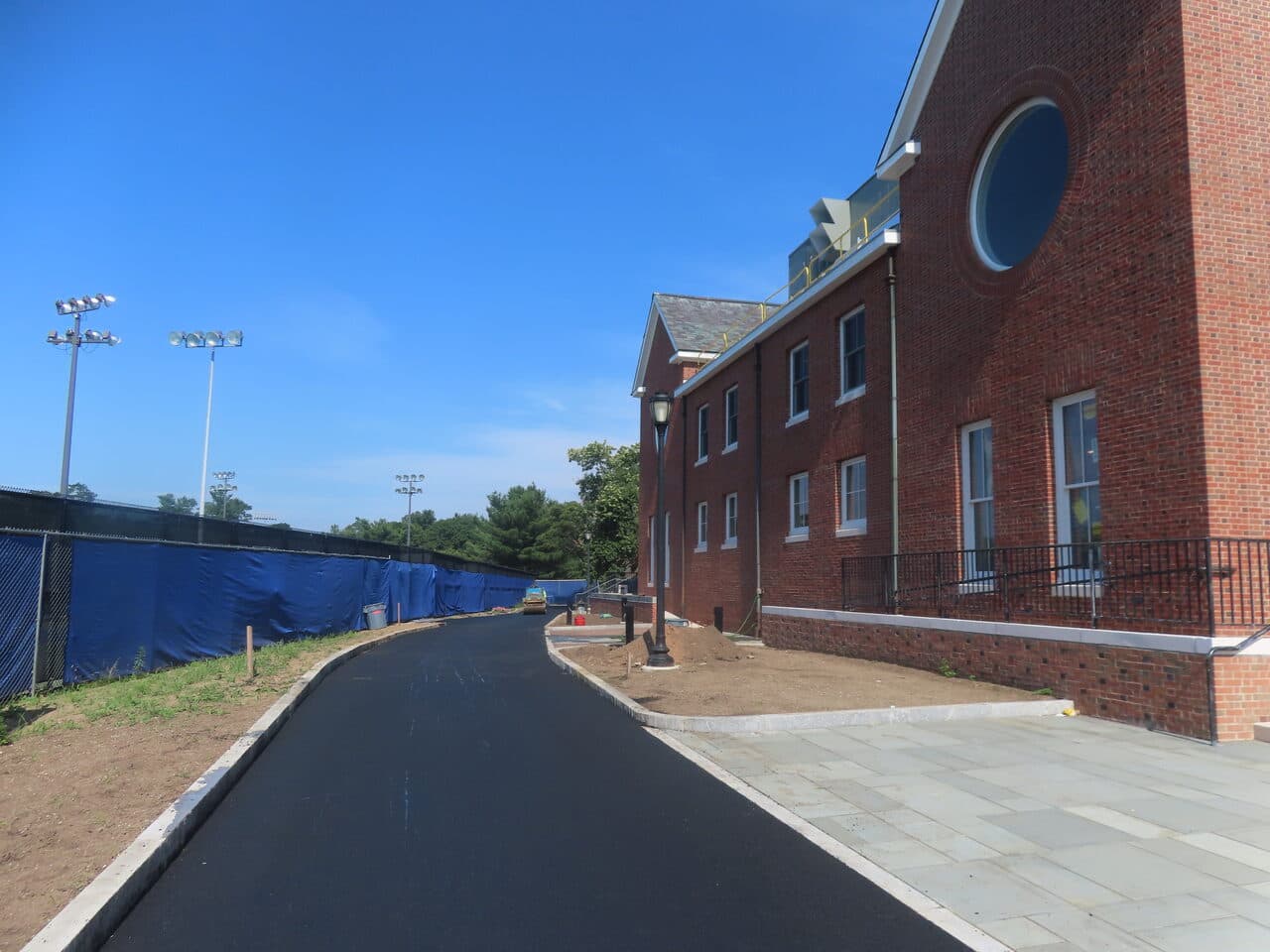 Institutional Asphalt Paving project in New Haven, CT — finished asphalt path beside brick building