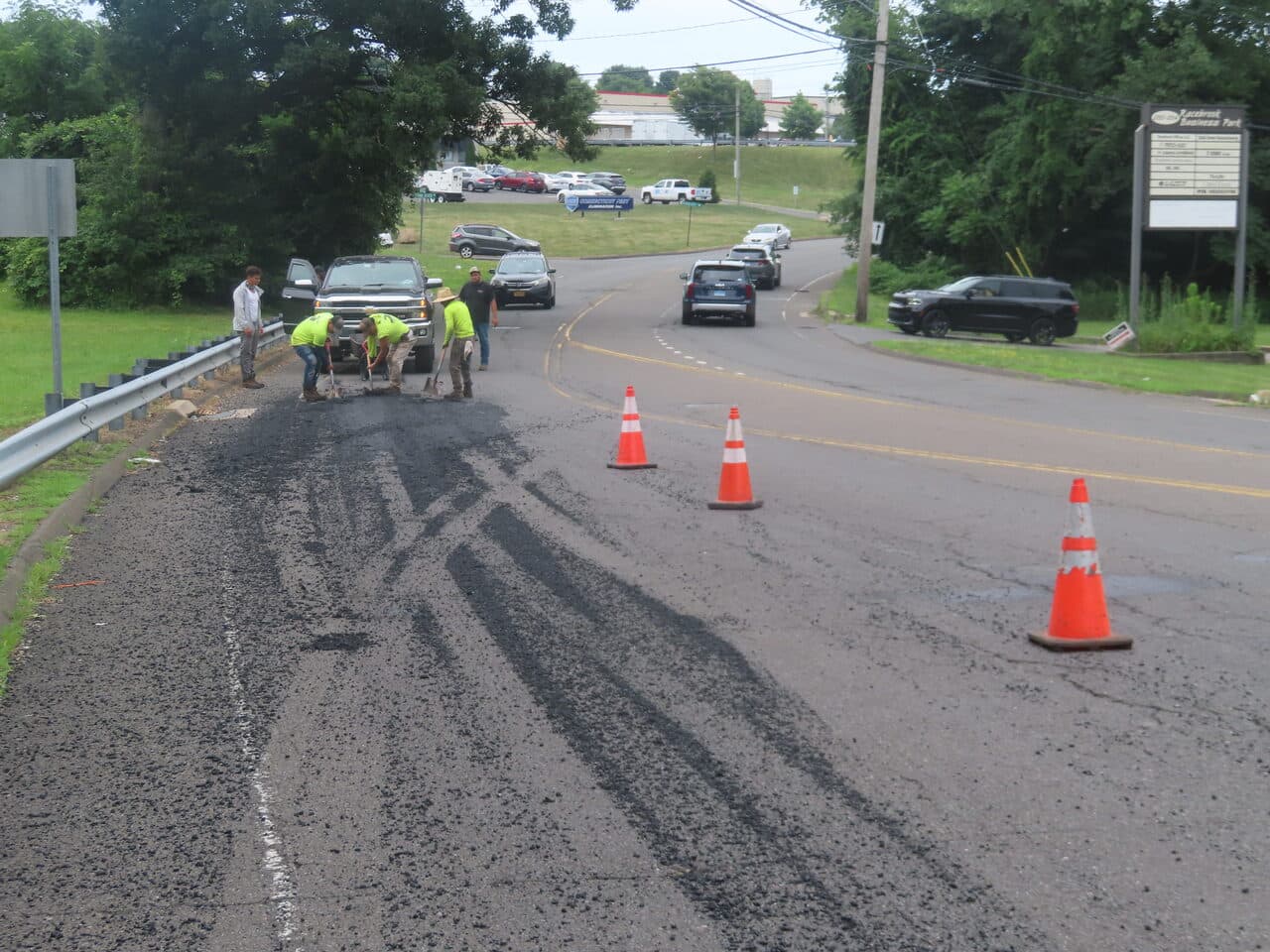 Commercial Parking Lot Paving project in Orange, CT — crew patching milled road potholes
