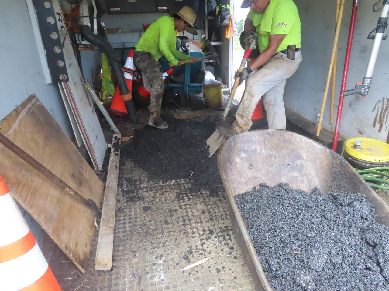 Commercial Parking Lot Paving project in Orange, CT — workers shoveling asphalt in truck bed