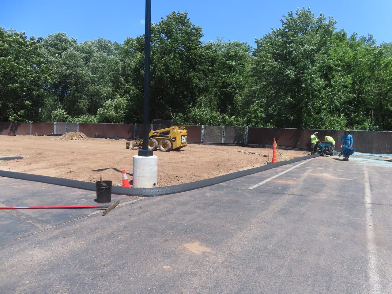Commercial Parking Lot Repair & Patching project in Wallingford, CT — catch basin and curb at dirt lot