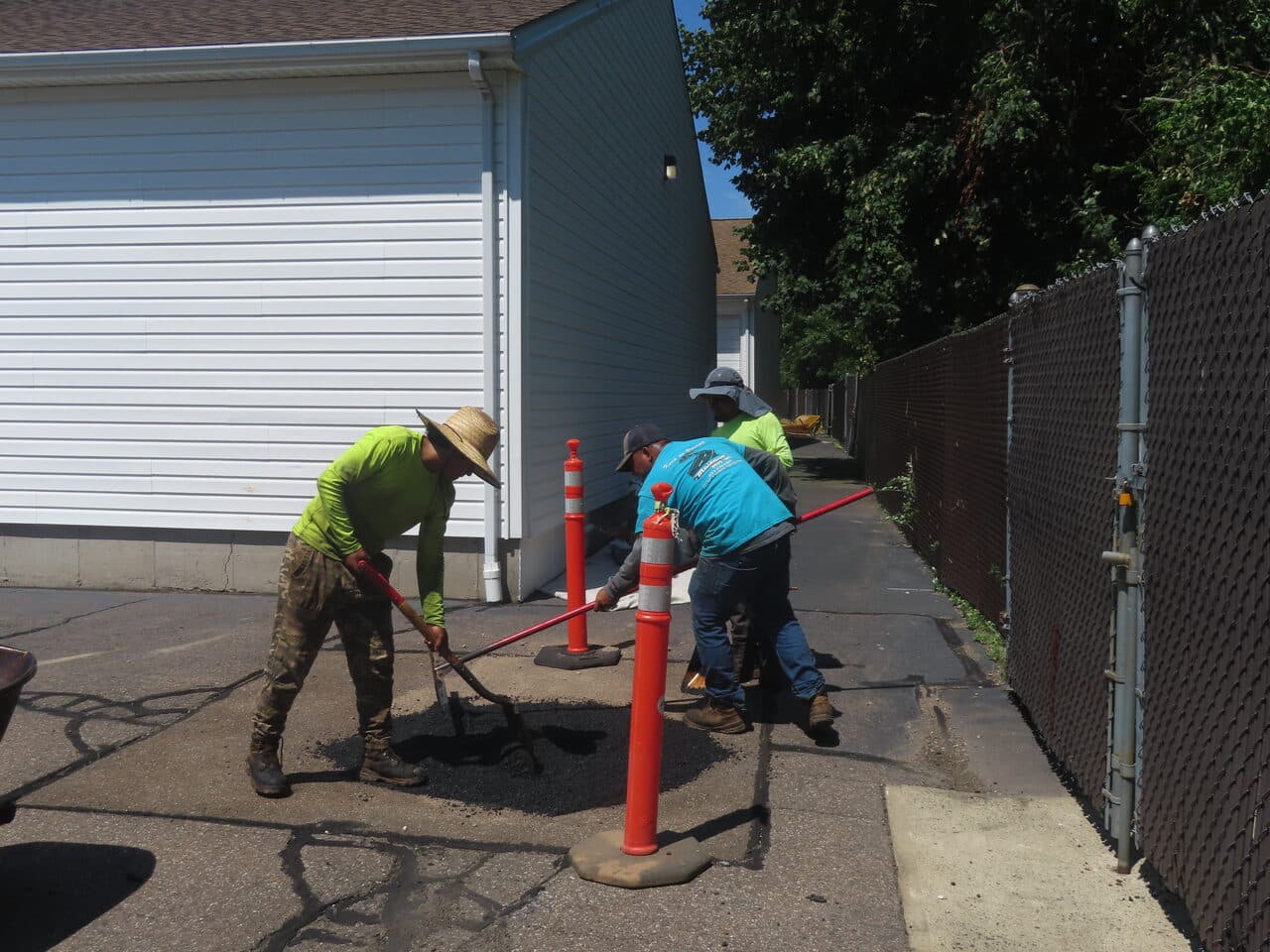 Commercial Parking Lot Repair & Patching project in Wallingford, CT — crew patching asphalt by walkway