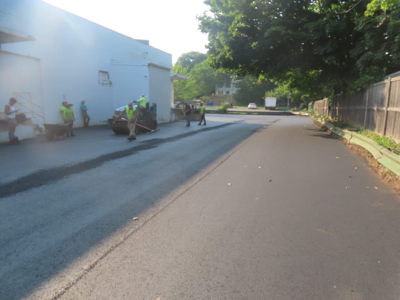 Commercial Parking Lot Paving project in Branford, CT — crew raking fresh asphalt