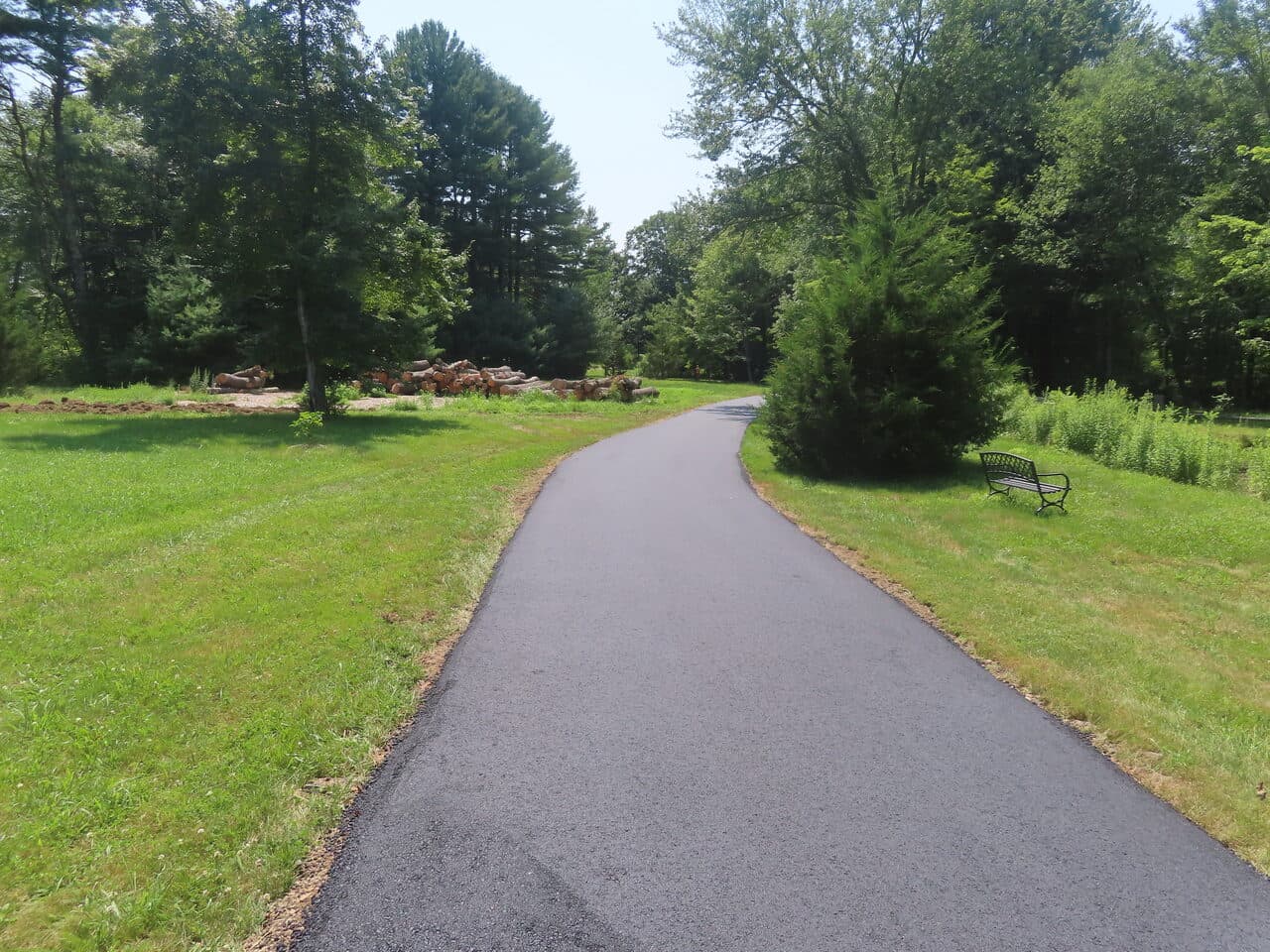 Pedestrian Trail & Parking Lot Paving project in Guilford, CT — curving drive with bench
