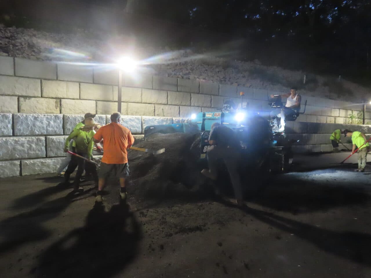 Commercial Parking Lot Paving project in Guilford, CT — night paving crew raking asphalt