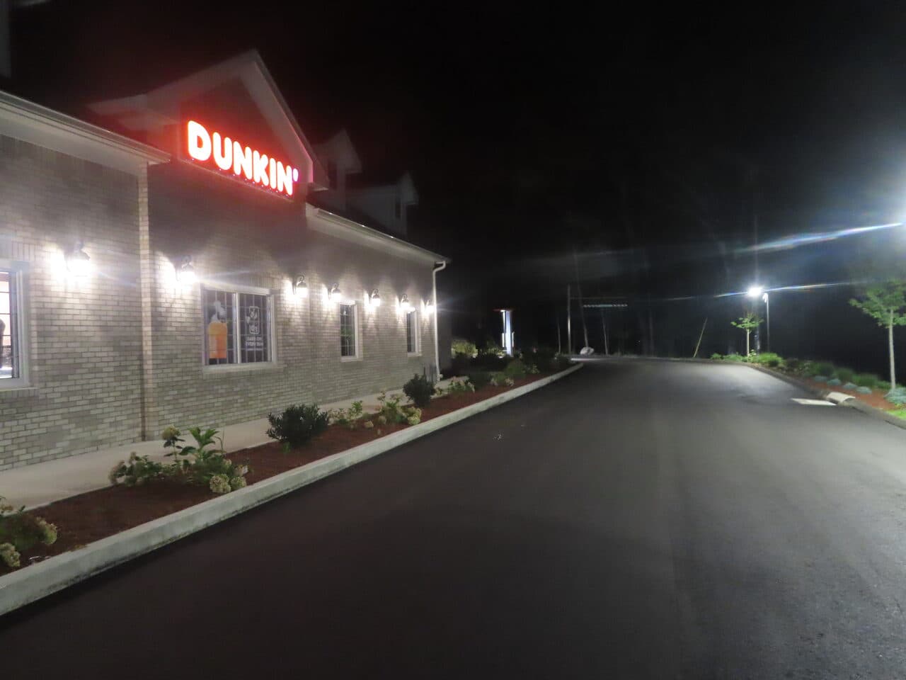 Commercial Parking Lot Paving project in Guilford, CT — finished asphalt by Dunkin building