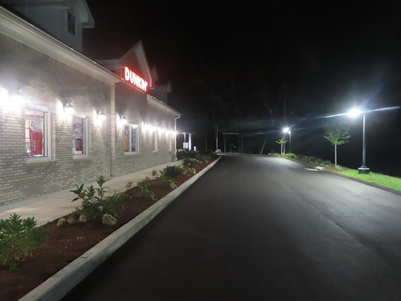 Commercial Parking Lot Paving project in Guilford, CT — finished asphalt along Dunkin building