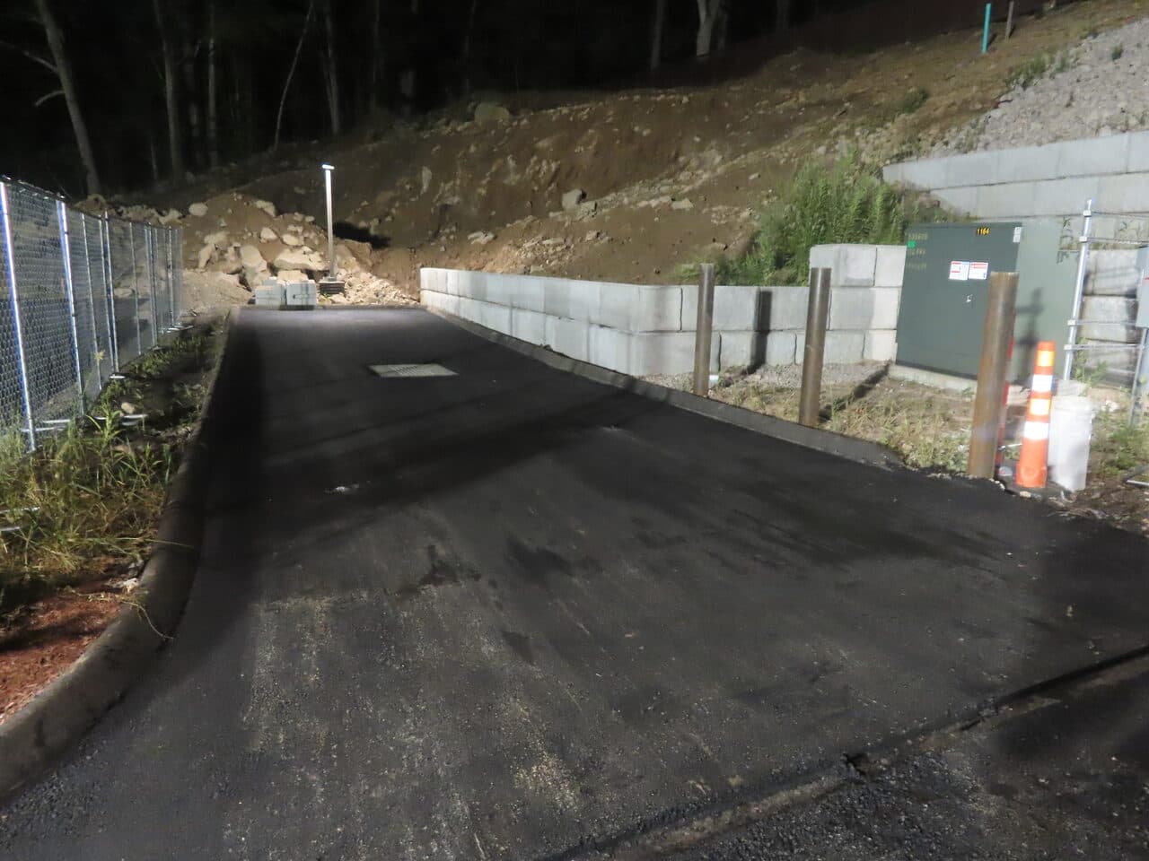 Commercial Parking Lot Paving project in Guilford, CT — finished access drive with retaining wall