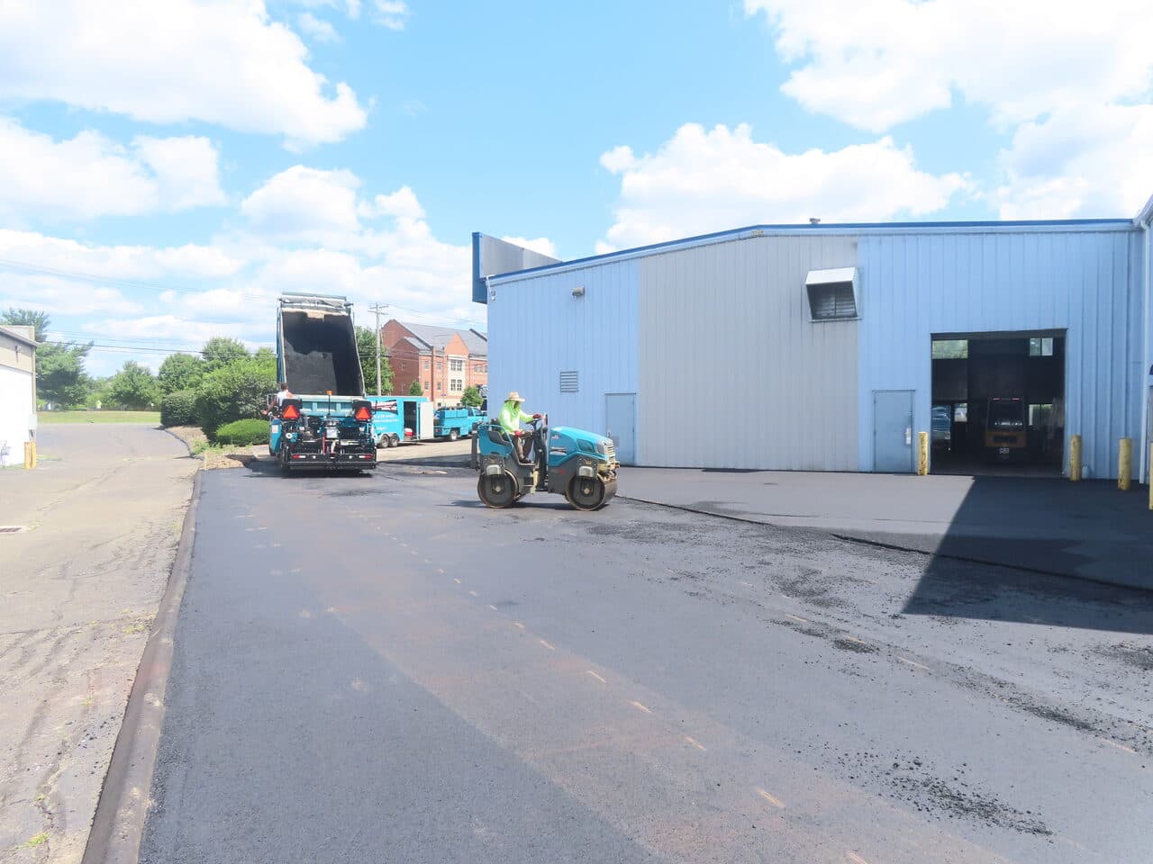 Commercial Parking Lot Paving project in North Haven, CT — paver and roller laying asphalt