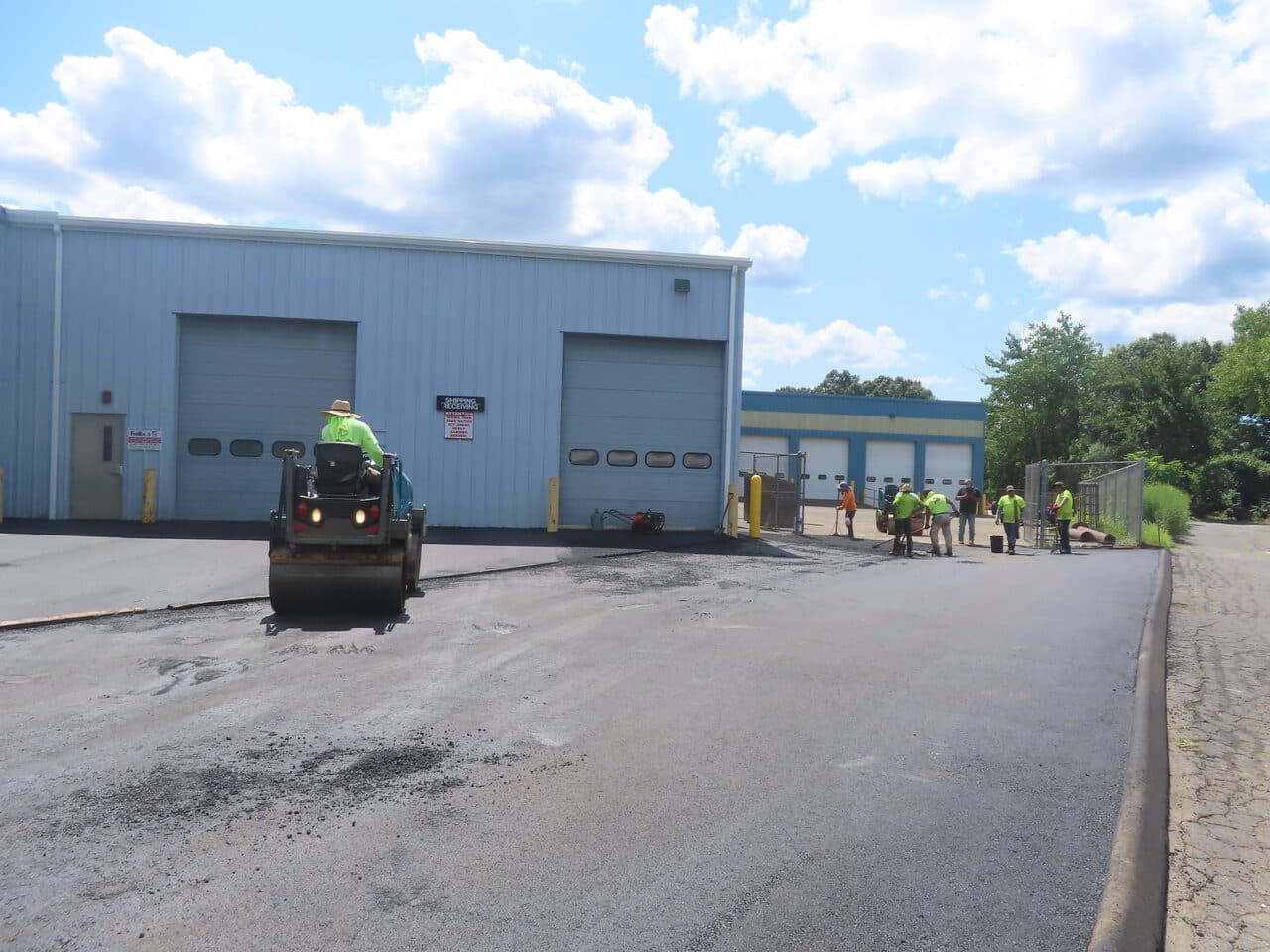 Commercial Parking Lot Paving project in North Haven, CT — roller on fresh asphalt by docks