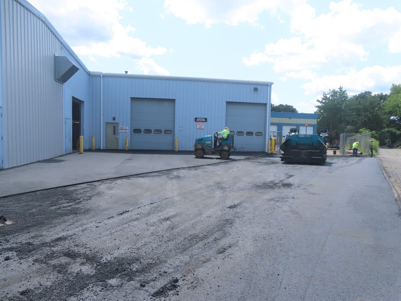 Commercial Parking Lot Paving project in North Haven, CT — roller and paver near docks