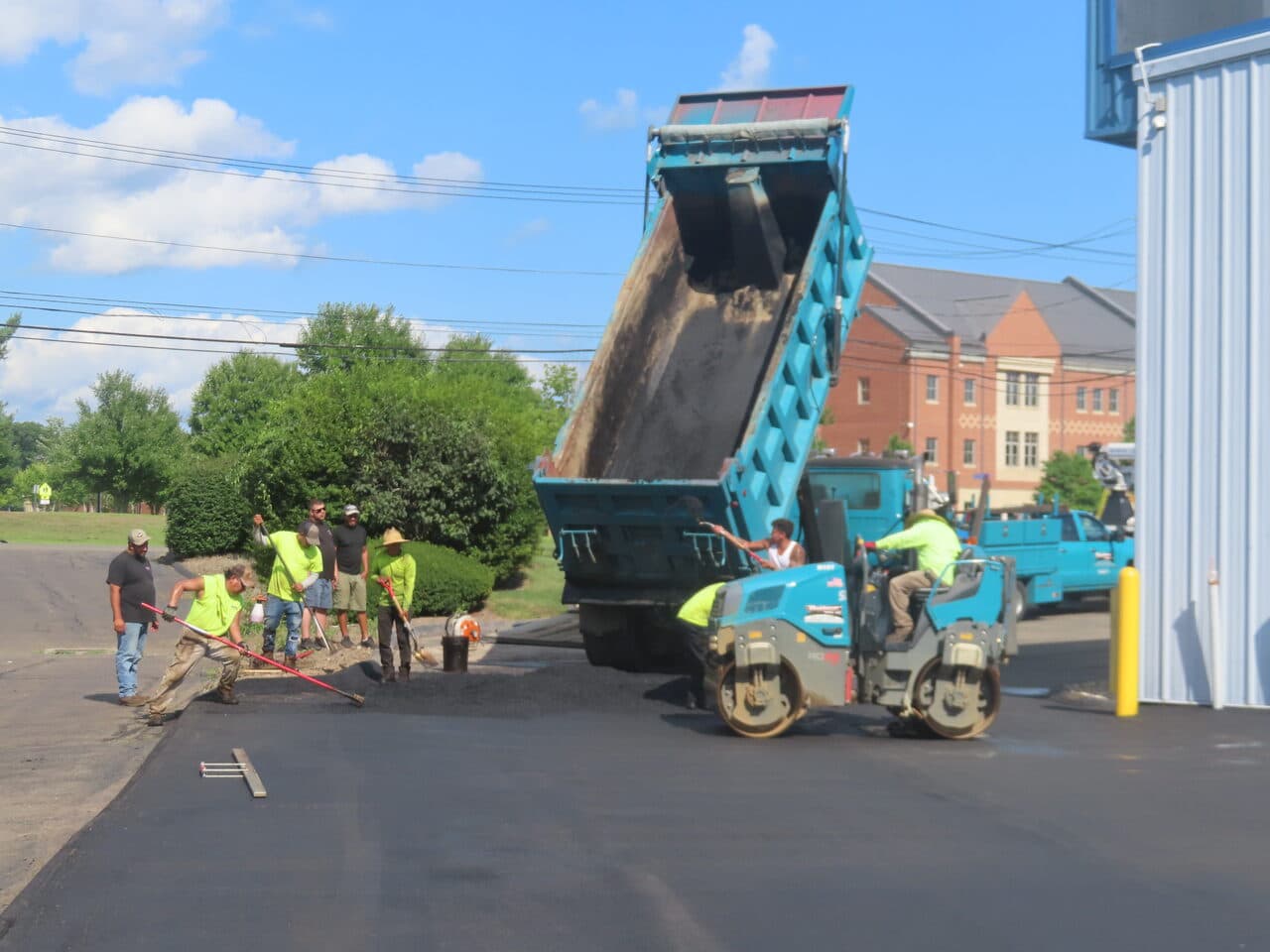 Commercial Parking Lot Paving project in North Haven, CT — crew raking asphalt at dump truck