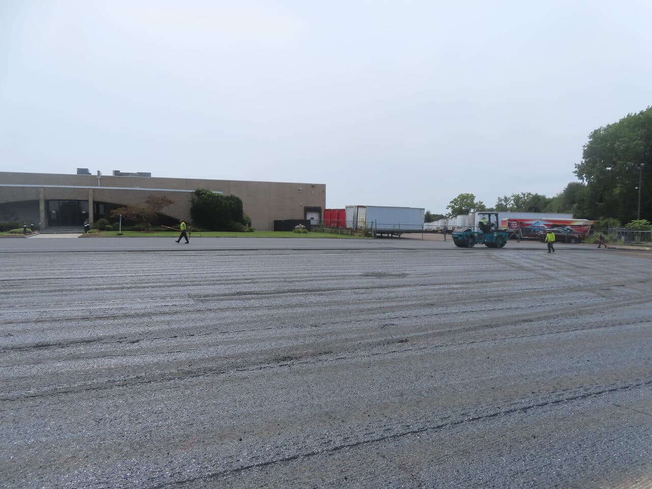 Commercial Parking Lot Paving project in East Haven, CT — milled lot with roller during paving