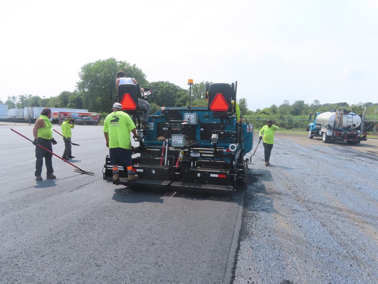 Commercial Parking Lot Paving project in East Haven, CT — paver crew laying asphalt