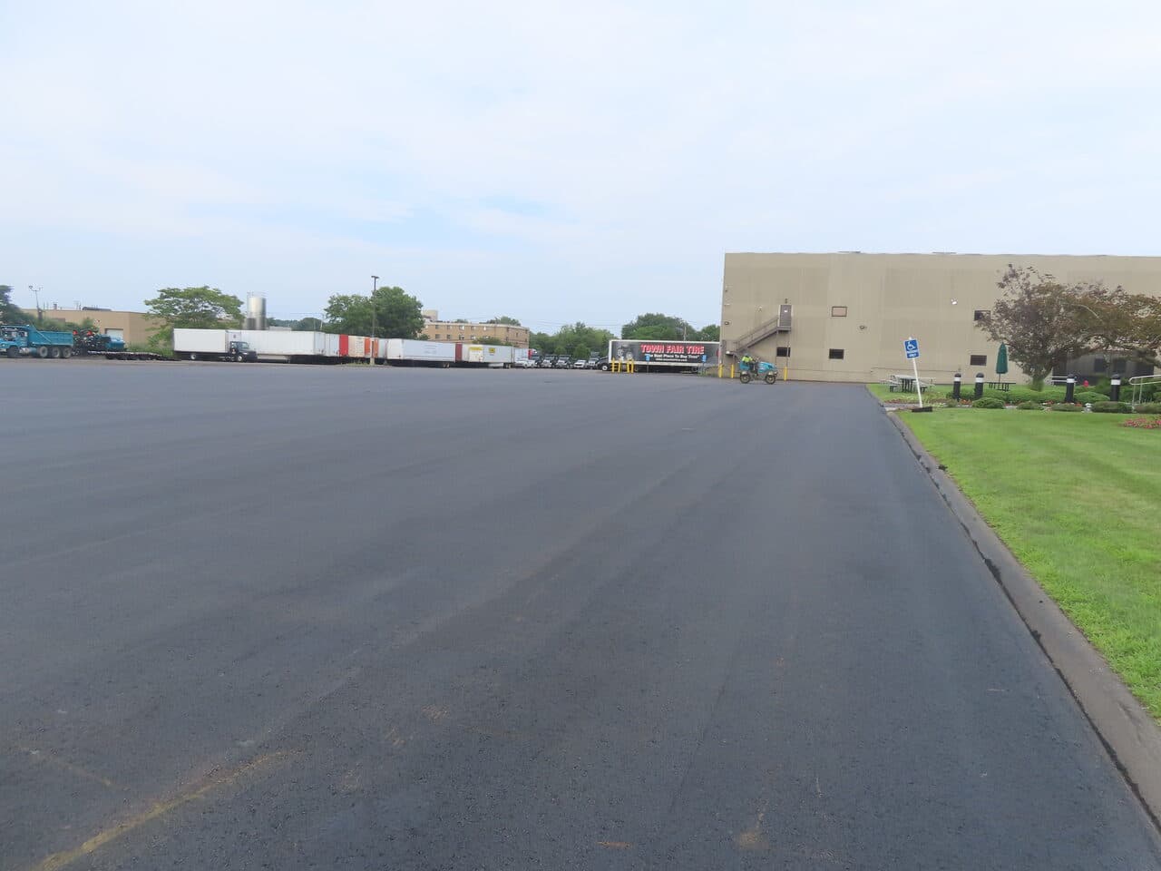 Commercial Parking Lot Paving project in East Haven, CT — finished lot edge along warehouse