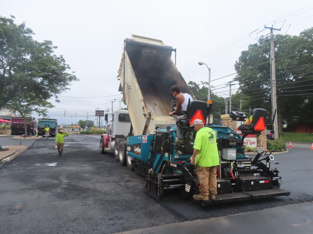 Commercial Parking Lot Paving project in Shelton, CT — dump truck feeding paver