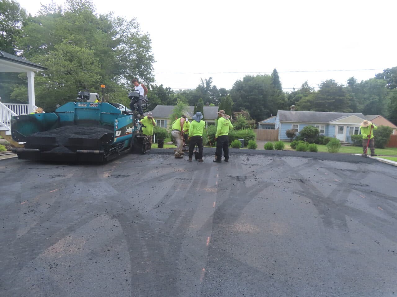 Commercial Parking Lot Paving project in Branford, CT — paver laying asphalt with crew