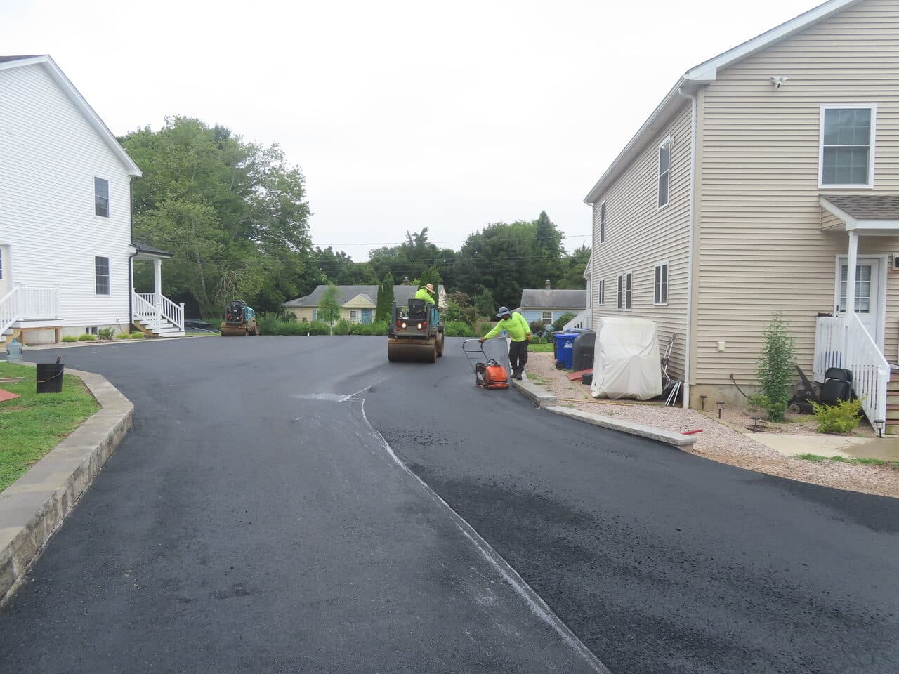 After — Commercial Parking Lot Paving in Branford, CT (crew brooming fresh asphalt)