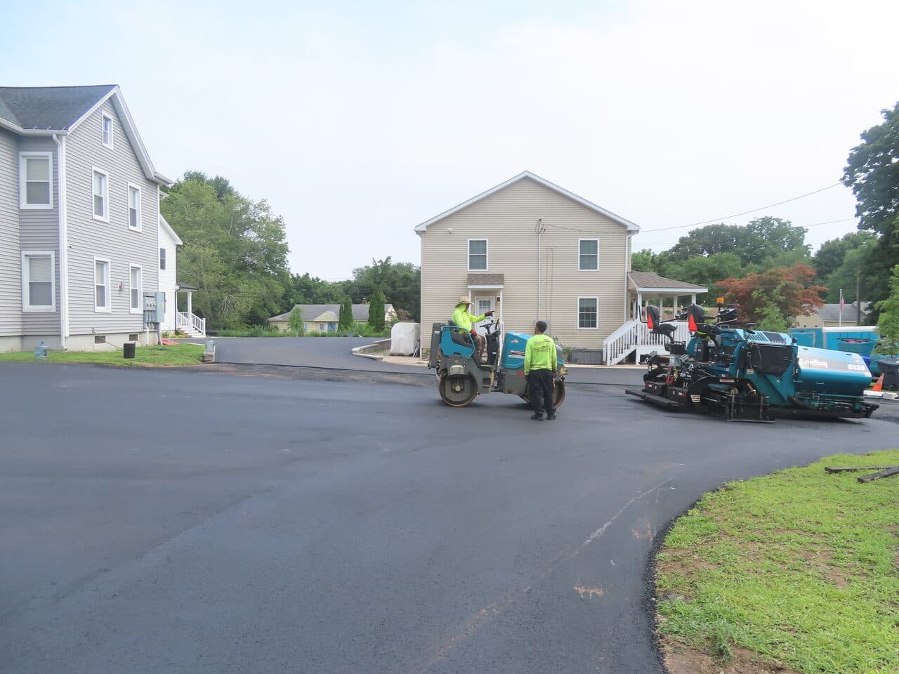 Commercial Parking Lot Paving project in Branford, CT — finished lot with paver and roller