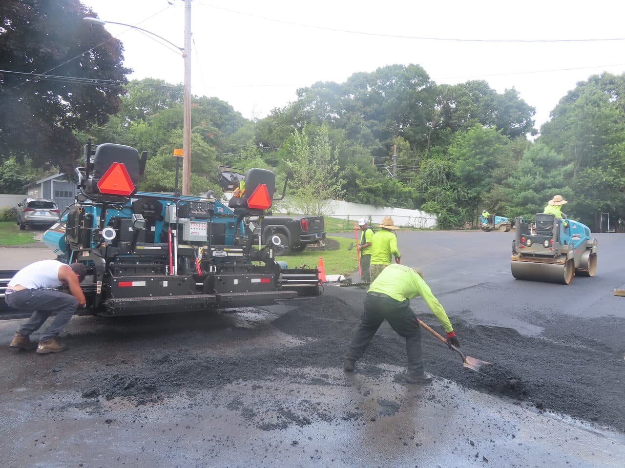 Commercial Parking Lot Paving project in Branford, CT — paver and crew spreading asphalt