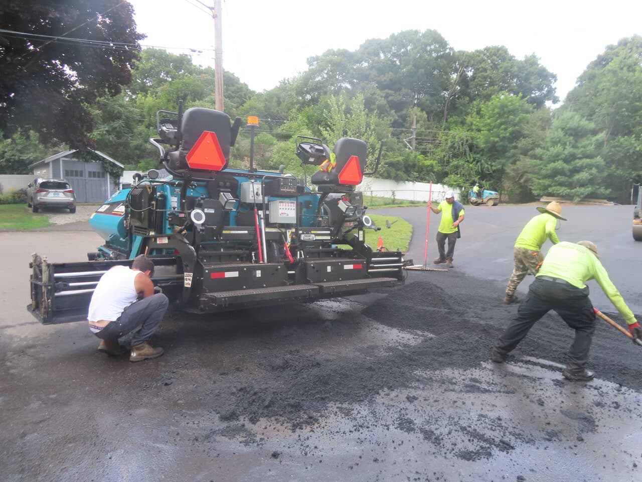 Commercial Parking Lot Paving project in Branford, CT — paver back with crew shoveling