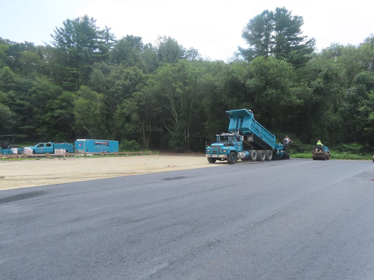 Commercial Parking Lot Paving project in Brooklyn, CT — dump truck feeding paver new lot