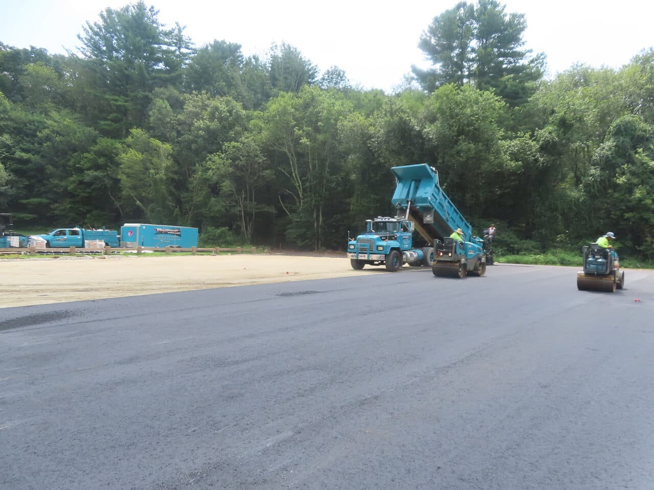 Commercial Parking Lot Paving project in Brooklyn, CT — paving train laying asphalt