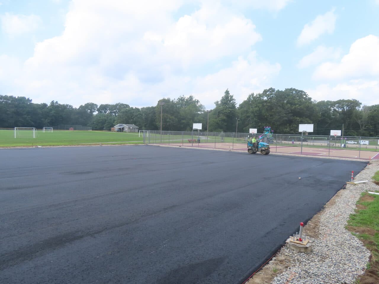 Commercial Parking Lot Paving project in Brooklyn, CT — fresh asphalt lot at sports complex
