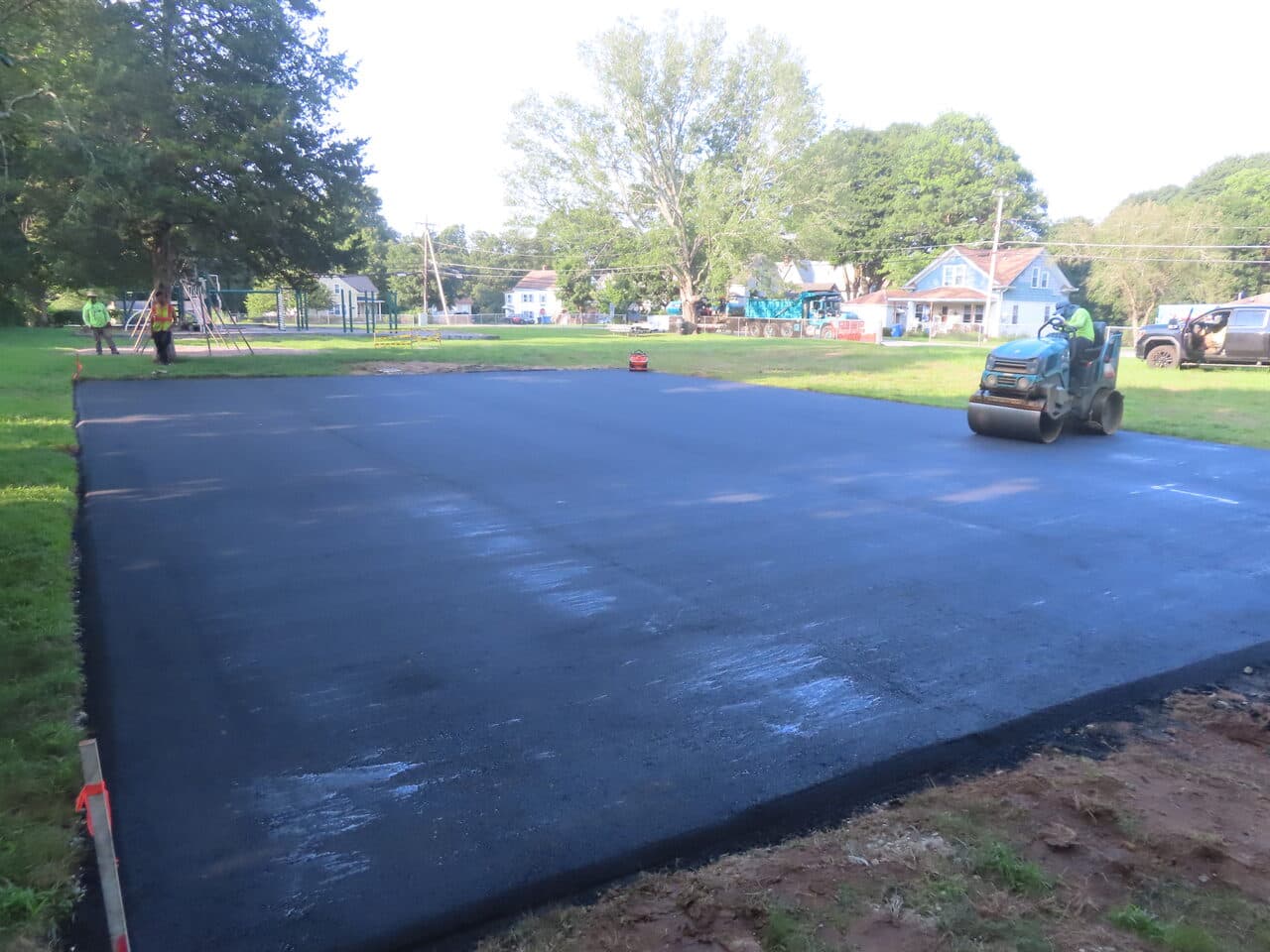 After — Commercial Parking Lot Paving in Brooklyn, CT (paving in progress near house)