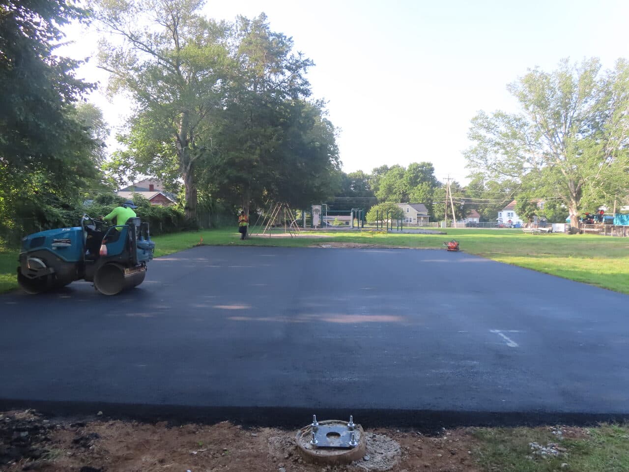 Commercial Parking Lot Paving project in Brooklyn, CT — finished lot with roller at park