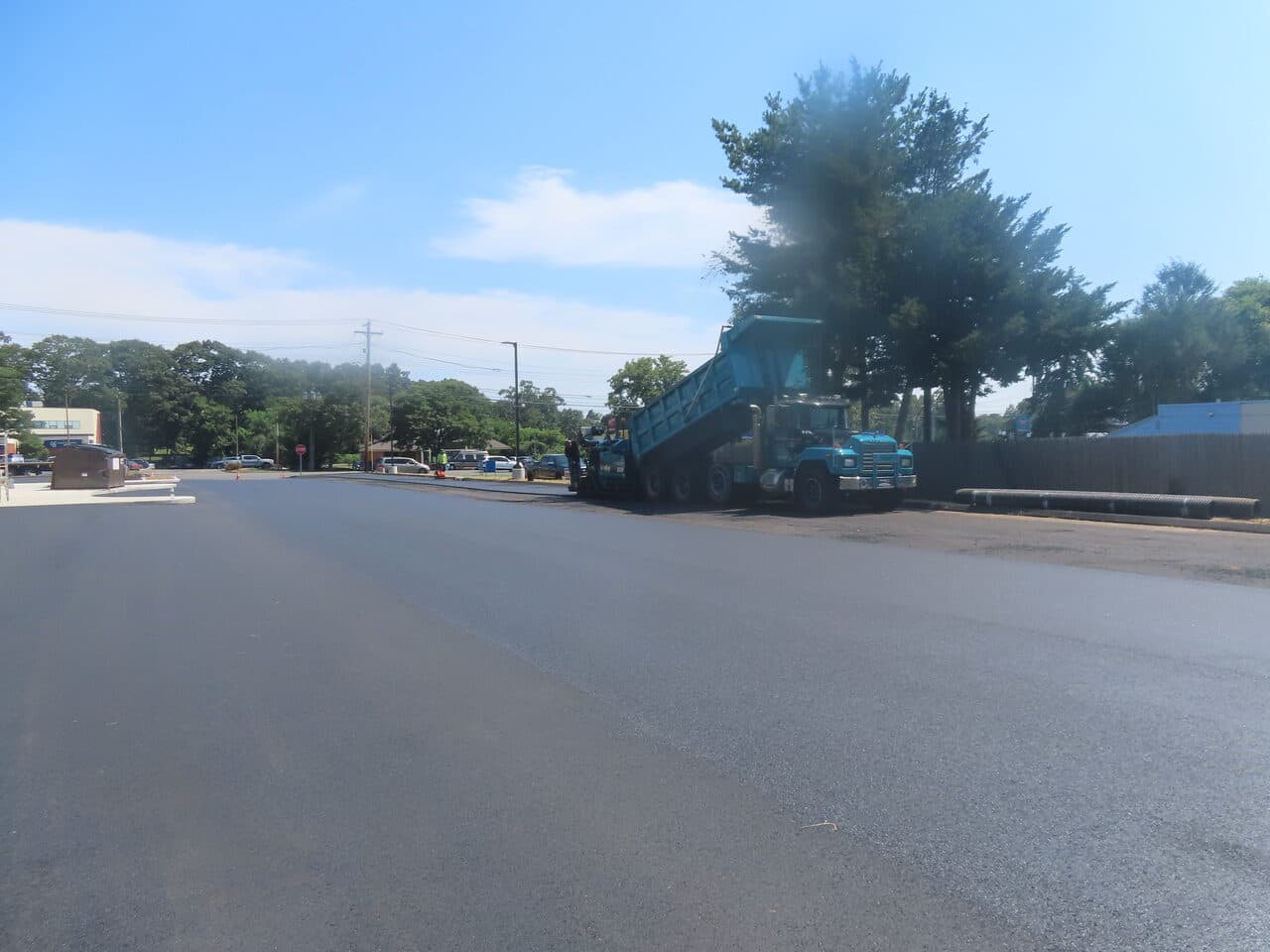 Commercial Parking Lot Paving project in Orange, CT — fresh paving with truck and paver