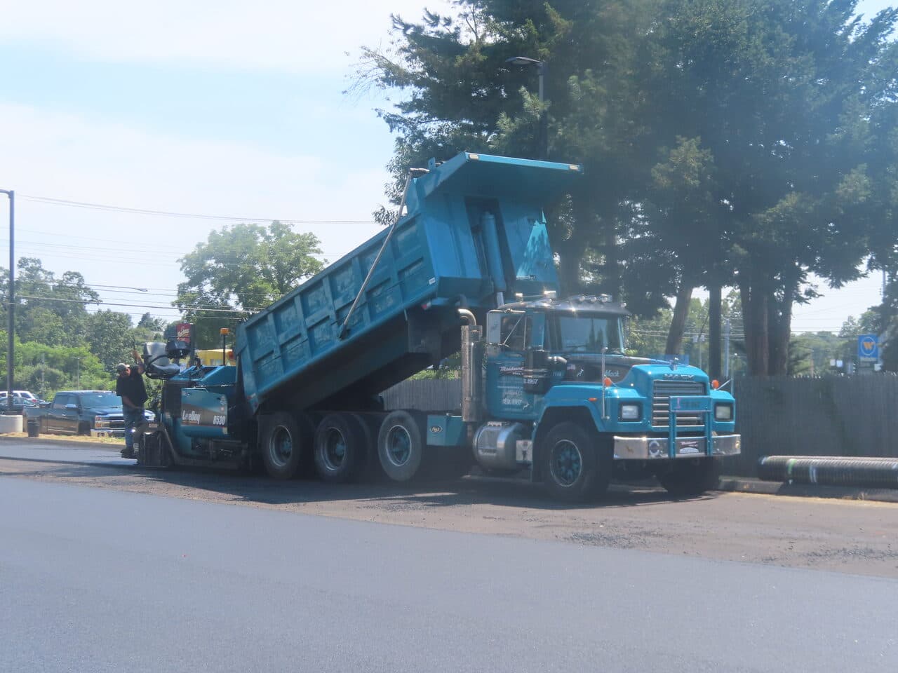 Commercial Parking Lot Paving project in Orange, CT — Maisano dump truck feeding paver
