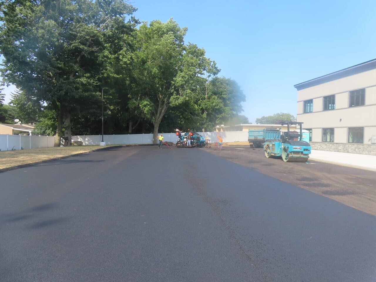 Commercial Parking Lot Paving project in Orange, CT — paving crew with paver and roller