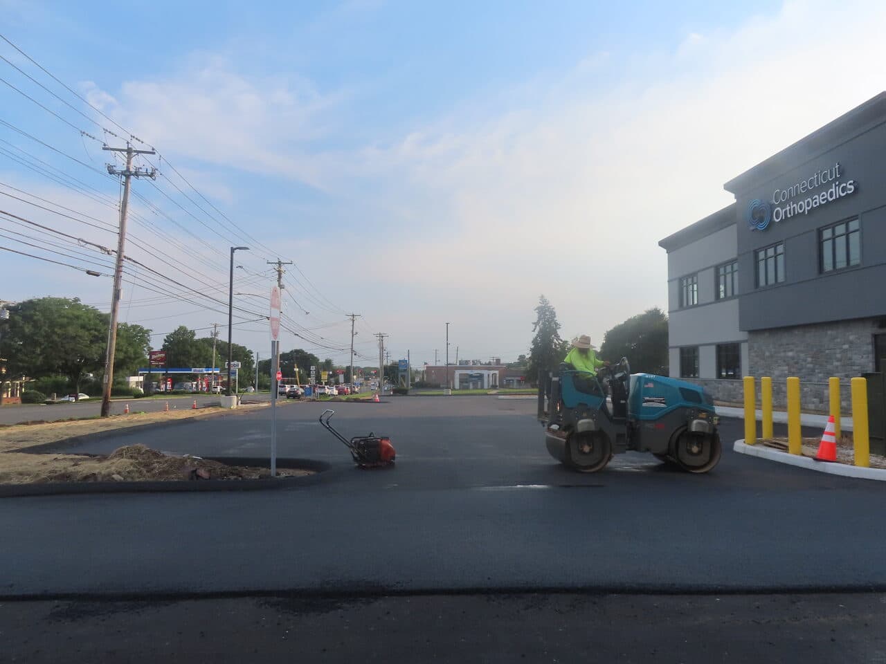 Commercial Parking Lot Paving project in Orange, CT — roller at lot entrance by roadway