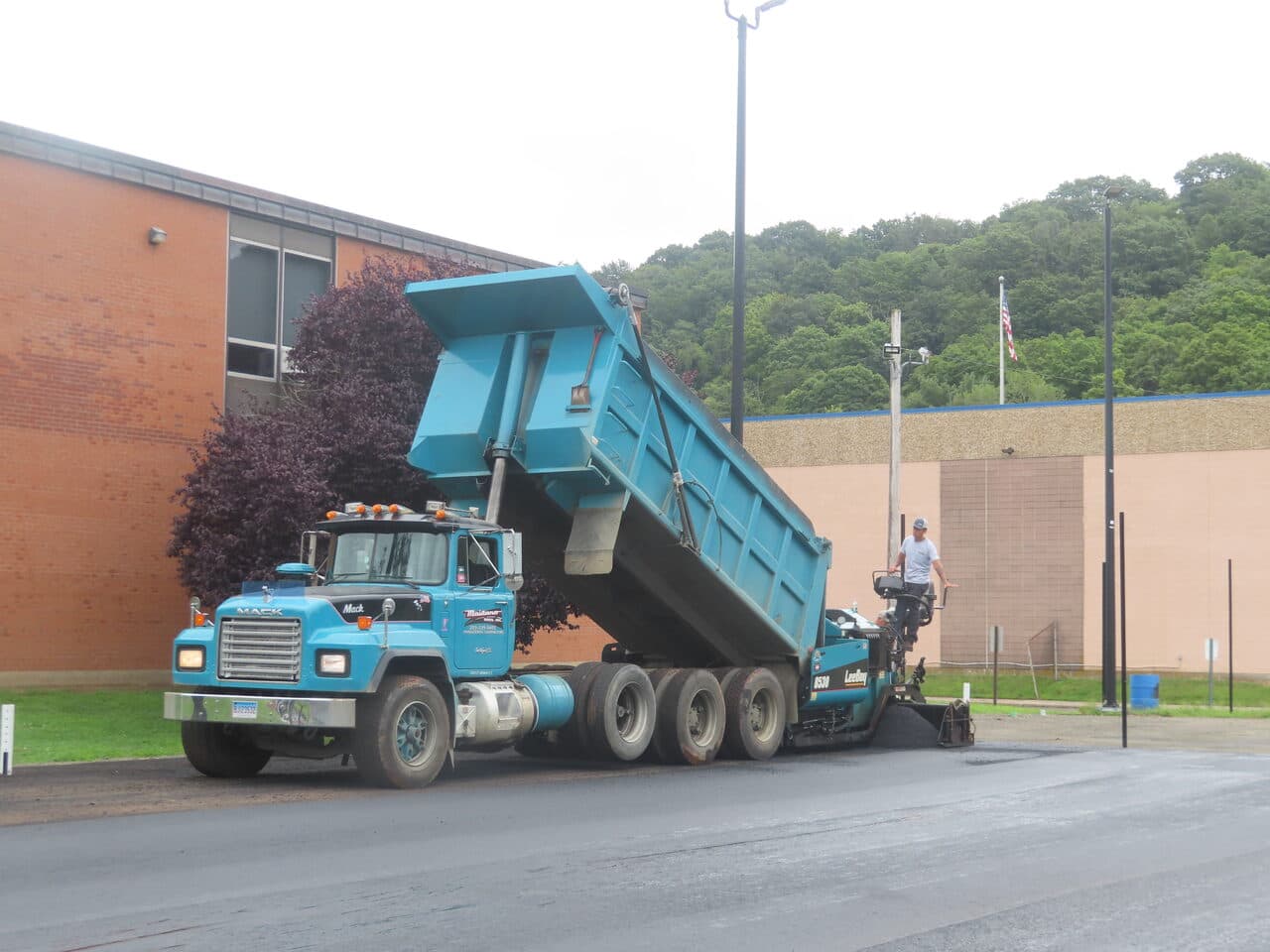 Commercial Parking Lot Paving project in East Haven, CT — dump truck loading paver