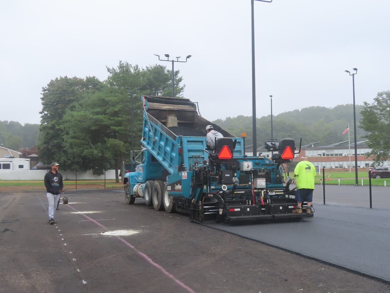 Commercial Parking Lot Paving project in East Haven, CT — paver and dump truck laying asphalt