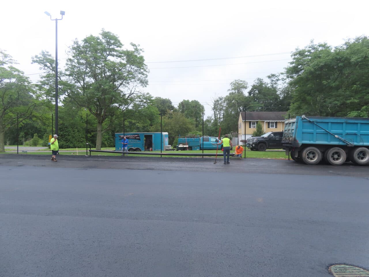 Commercial Parking Lot Paving project in East Haven, CT — finished lot with crew and trucks
