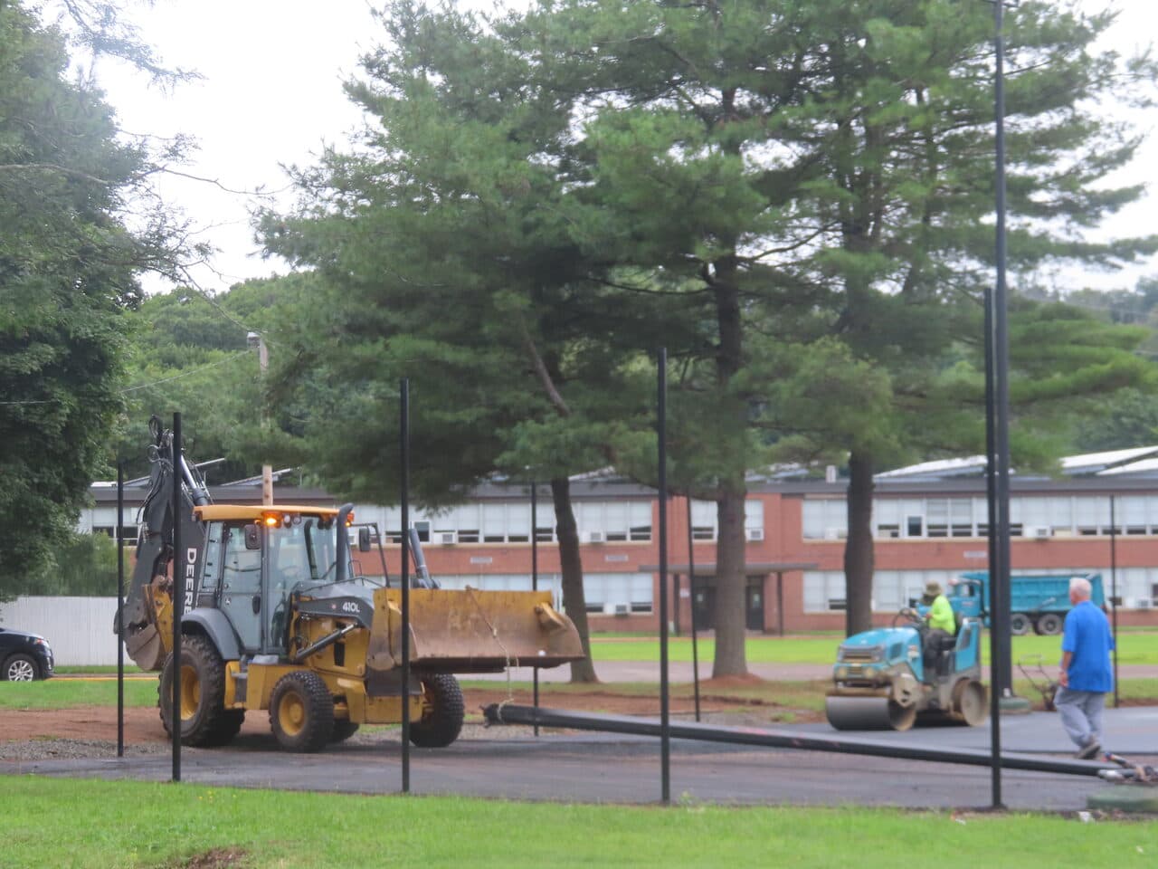 Commercial Parking Lot Paving project in East Haven, CT — Deere backhoe and roller working