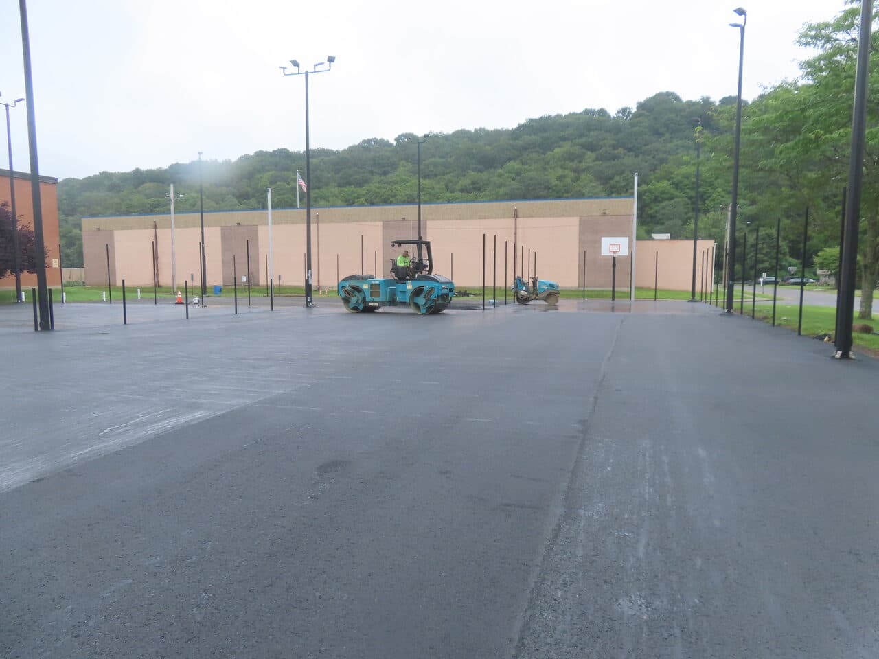 Commercial Parking Lot Paving project in East Haven, CT — roller compacting fresh asphalt lot