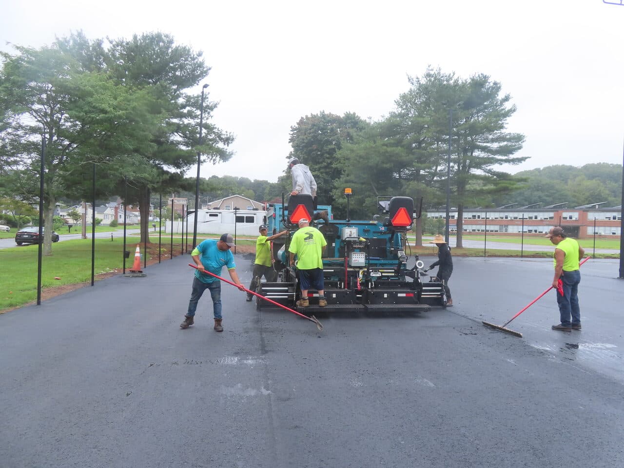 Commercial Parking Lot Paving project in East Haven, CT — crew raking behind paver