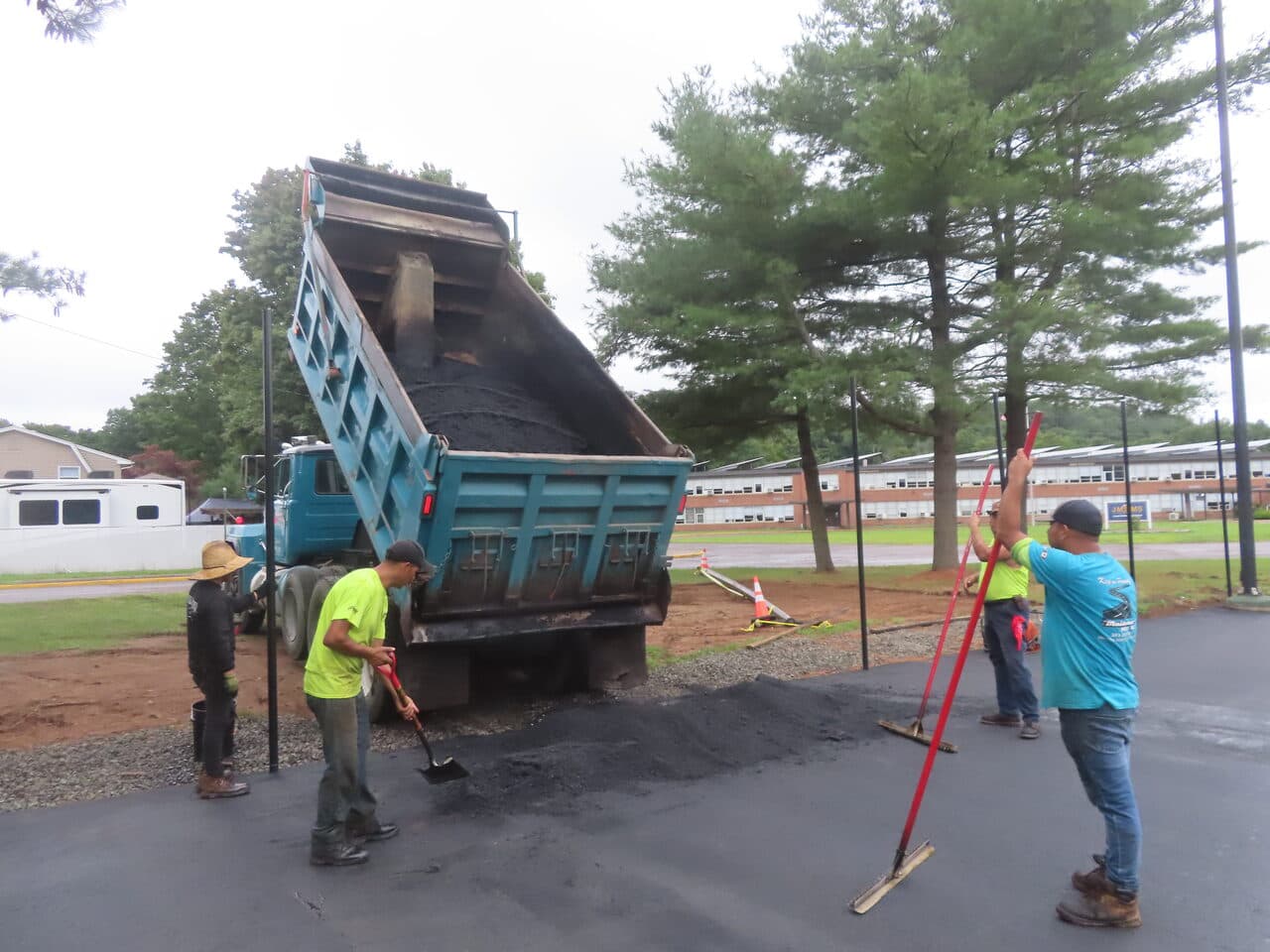 Commercial Parking Lot Paving project in East Haven, CT — dumping asphalt crew spreading