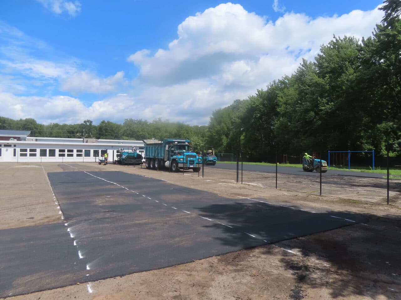 After — Commercial Parking Lot Paving in Bloomfield, CT (bare lot before paving with fence posts)